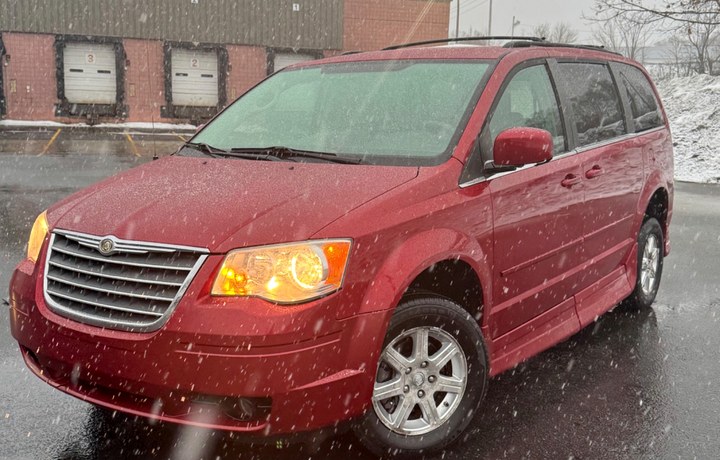 Red Chrysler Town and Country medical transportation van